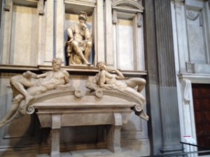 Three sculptures by Michelangelo in the New Sacristy of the Medici Chapels in San Lorenzo Florence. This room was peaceful and quiet after the hectic triumphalism of the Principal chapel. In this quiet space are the relatively unadorned tombs of Lorenzo the Magnificent himself and his murdered brother Giuliano (C15th)