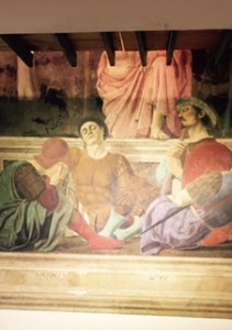 Just part of Piero della Francesca's painting of the resurrection because the upper half is being restored and is covered by a platform under which I took this photo  Francesca painted himself as the second soldier from left asleep.