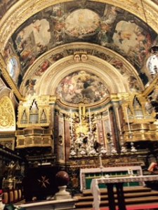 The highly ornate sanctuary of St John's Co-Cathedral with gilt everywhere.