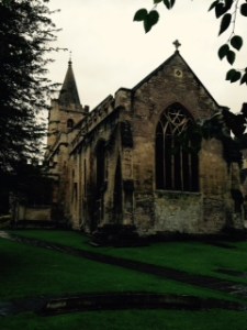 Exterior of Holy Trinity Bradford on Avon dating from C12th with many gravestones, most unreadable