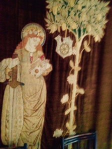 Textile wall hanging of St Catherine worked by Jane Morris in Kelmscott Manor