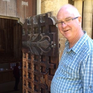 Ancient tiny carved front door at the base of the 