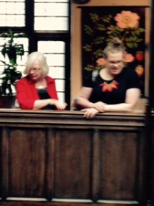 Two fashionistas observe Liberty proceedings from the sixth floor gallery