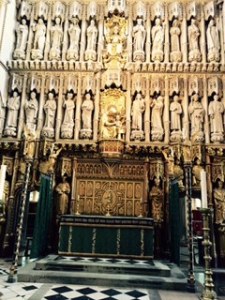Impressive carved and modelled bronze and wooden screen behind the high altar with figures prominent in the church's long history